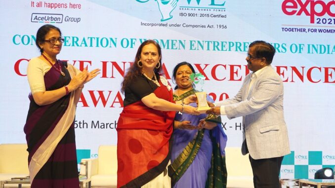 Rachna Kalra, a woman entrepreneur seen being felicitated with COWE India Excdellence Award