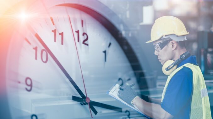 Engineer worker looking service check list in factory overlay wi