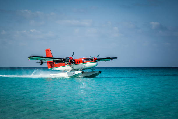 The takeoff of a seaplane from the ocean beach.