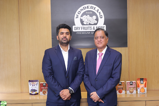 National, 23 October 2025 - Wonderland Foods, a Delhi NCR–based healthy snacking brand, has raised INR 140 crore in its first institutional funding round, led by Asha Ventures and British International Investments (BII), the UK’s development finance institution and impact investor.
The investment will fuel Wonderland’s next phase of growth by launching a range of innovative value-added products and deepening its distribution presence across channels to cement its leadership in the fast-growing branded health snacking market. The investment will help the company set up a green processing facility and generate 1,000+ formal jobs primarily for women. 
Wonderland has grown into a fast-scaling consumer brand over the last few years on the back of a commitment to quality and innovation. Wonderland products already have a prominent presence across modern trade chains and top e-commerce platforms, including Amazon, Flipkart, Swiggy Instamart, Blinkit, and Zepto.
Beyond business growth, Wonderland has also built a strong impact footprint, employing nearly 1,000 workers in its production facilities, mostly women, thereby supporting sustainable job creation and economic empowerment. The company is also eligible to qualify for 2X Challenge, a global initiative in driving women empowerment. 
“At Wonderland, we’ve always believed that quality and trust are the foundation of a strong consumer brand. This funding marks a pivotal moment for us as we scale our distribution, launch new products, and take the next big leap in our growth journey. We’re proud to partner with the Government of Uttar Pradesh to set up a INR 250 crore greenfield nuts and dry fruits processing unit at Greater Noida, which will create employment opportunities for over 1,000 women and further strengthen India’s food processing ecosystem,” said Mr. Rakesh Gupta, Founder and Mr. Anubhav Gupta, Managing Director of Wonderland Foods.
“What excites us about Wonderland is the rare combination of a strong cnsumer brand, differentiated product portfolio and wide distribution that have enabled the company to build scale efficiently. The healthy snacking category is experiencing strong consumer tailwinds, and Wonderland is well-placed to lead the organised shift from loose, unbranded products to trusted, hygienic formats. We are delighted to partner with Rakesh and Anubhav on this journey, along with BII, in generating impact while building a sustainable consumer brand,” said Pramod Bhasin & Vikram Gandhi, Founding Partner at Asha Ventures.
“We’re delighted to work with our partner Asha Ventures in supporting Wonderland Foods as it scales its operations and deepens its impact. The company’s commitment to creating formal jobs for women while building green facilities aligns strongly with BII’s mission to support inclusive and sustainable development in India,” said Shilpa Kumar, Managing Director and Head of India at British International Investments.