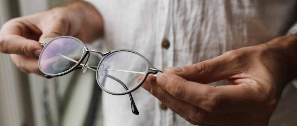 https://www.pexels.com/photo/close-up-of-hands-of-man-holding-eyeglasses-5712373/
